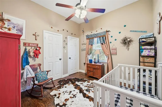 a bedroom with furniture and wooden floor