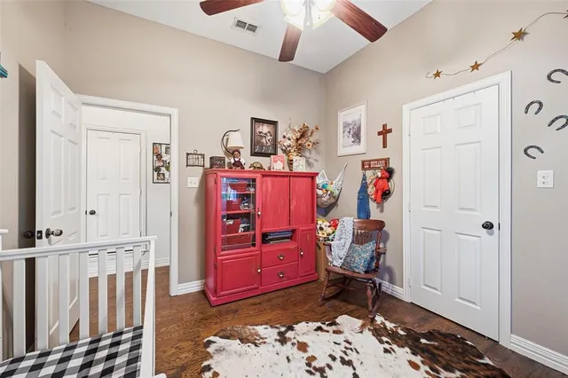 a view of a bedroom with baby crib