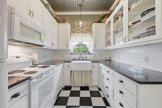 a kitchen with stainless steel appliances granite countertop a sink and a stove