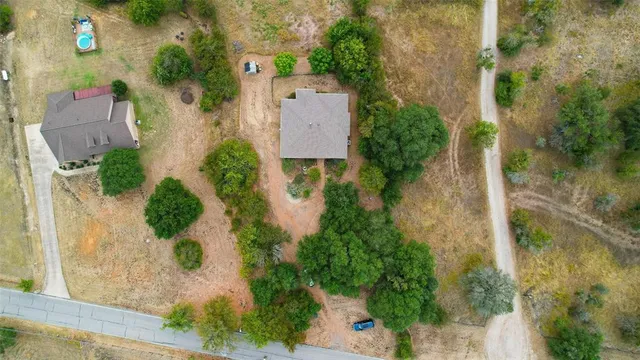 an aerial view of a house with outdoor space and street view