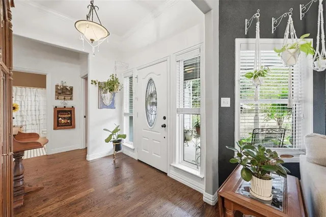 a view of an entryway with wooden floor and a livingroom view