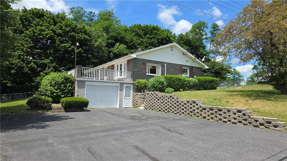 1237 Keller Road Wind Gap, PA 18091 - Photo 2 of 65 A well-maintained residence nestled into a verdant hillside, offering a peaceful outdoor setting.