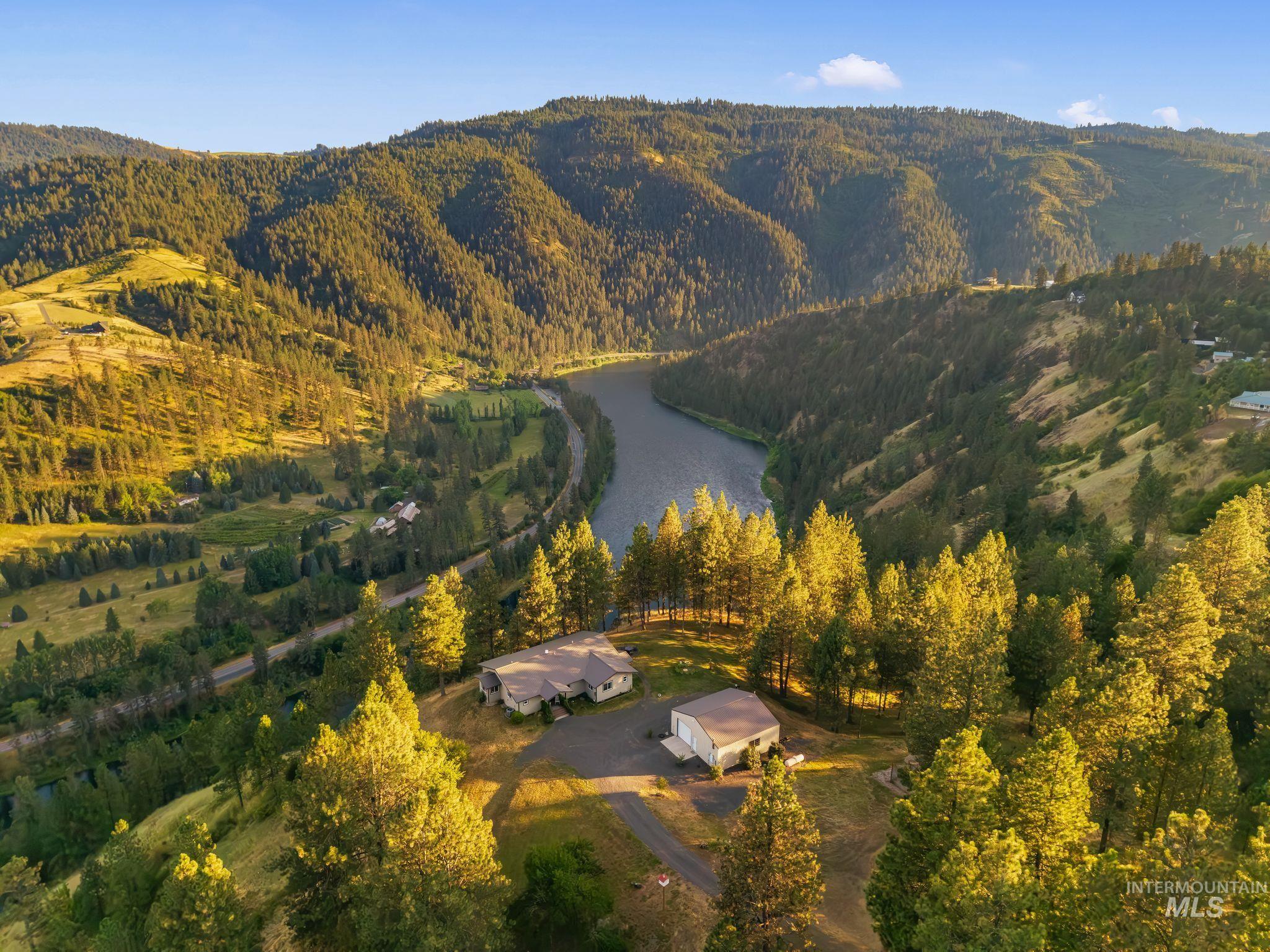 435 River Pointe Lane Lenore, ID 83541 - Photo 2 of 50 Expansive property featuring two structures, a winding river, and surrounding wooded hillsides