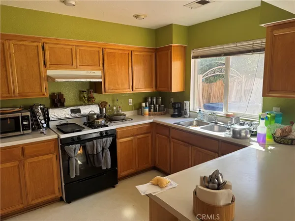 a kitchen with a sink stove and cabinets