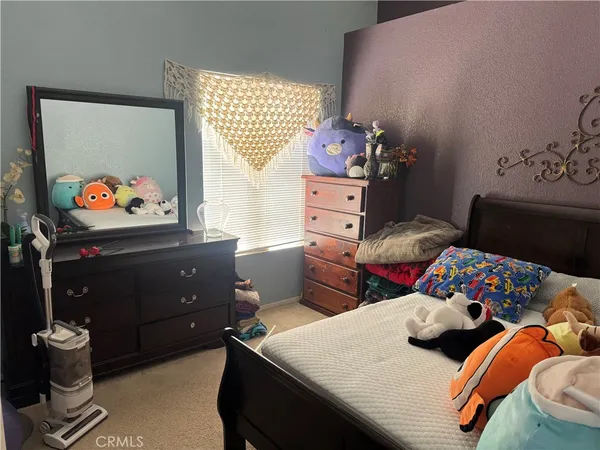 a bedroom with furniture and a dresser