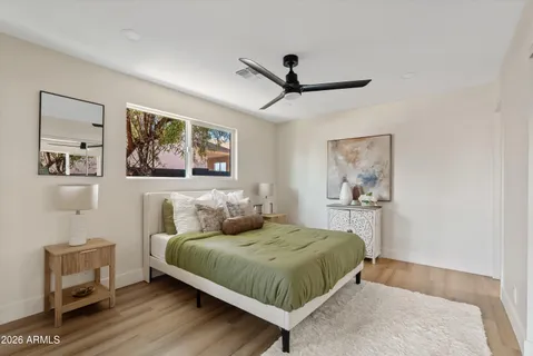 a bedroom with a large bed and a painting on the wall