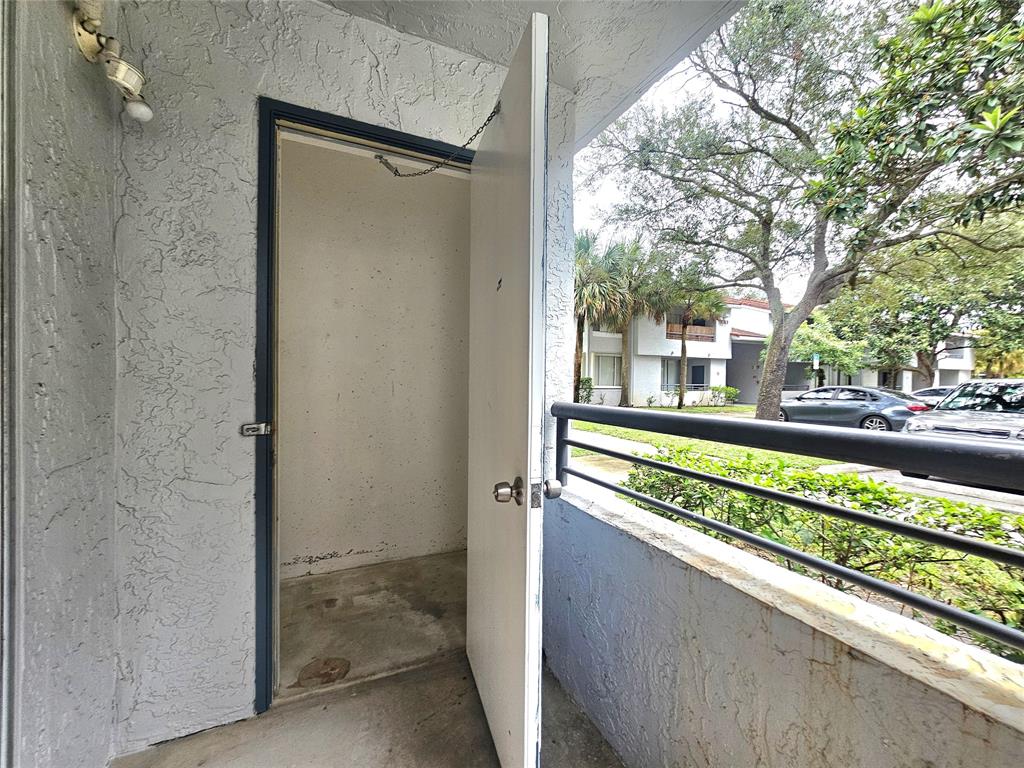 631 Lyons Road, Unit 12105 Coconut Creek, FL 33063 - Photo 13 of 26 a view of a balcony and car parked in the balcony