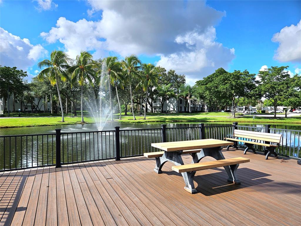 631 Lyons Road, Unit 12105 Coconut Creek, FL 33063 - Photo 18 of 26 a view of a lake with furniture