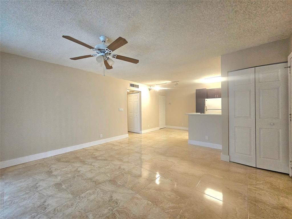 631 Lyons Road, Unit 12105 Coconut Creek, FL 33063 - Photo 2 of 26 a view of a livingroom with a ceiling fan