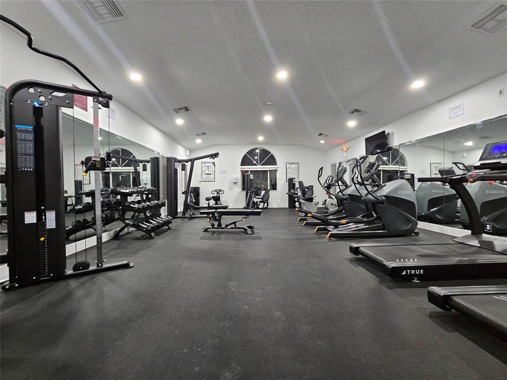 631 Lyons Road, Unit 12105 Coconut Creek, FL 33063 - Photo 23 of 26 a view of a room with gym equipment