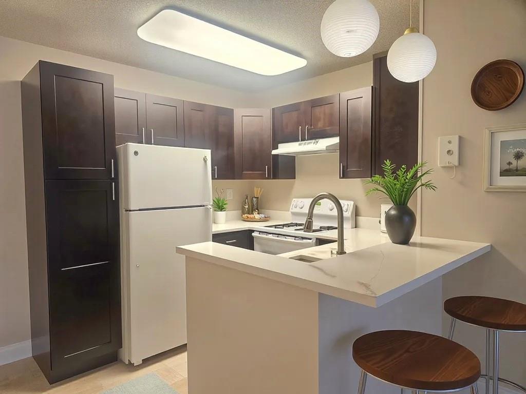 631 Lyons Road, Unit 12105 Coconut Creek, FL 33063 - Photo 5 of 26 a kitchen with a refrigerator and a sink