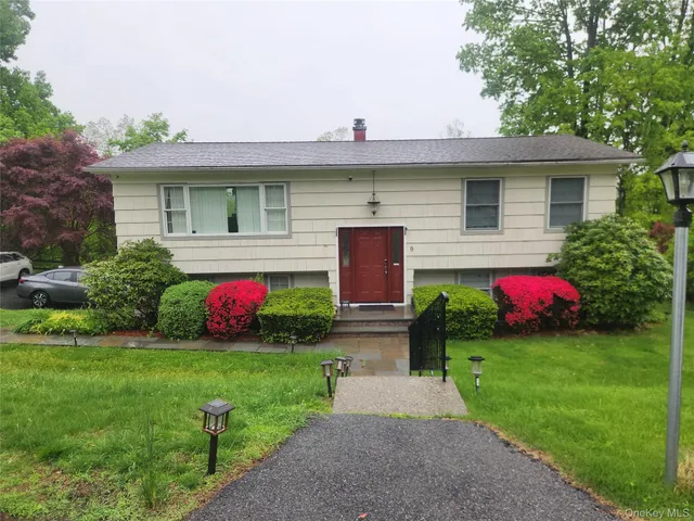 a front view of a house with a yard and a fence