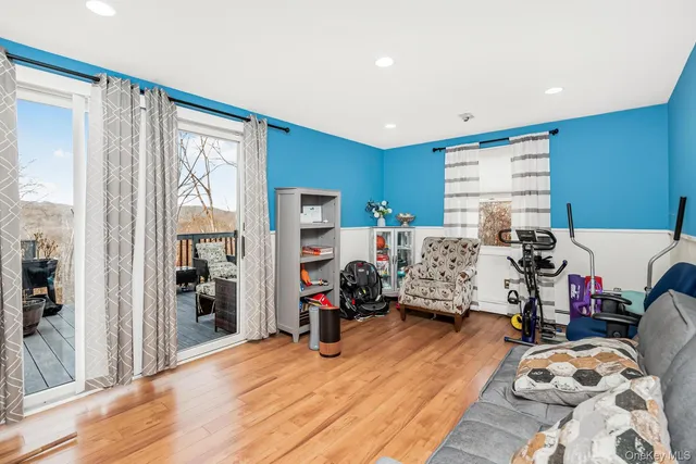 a bedroom with furniture and a wooden floor