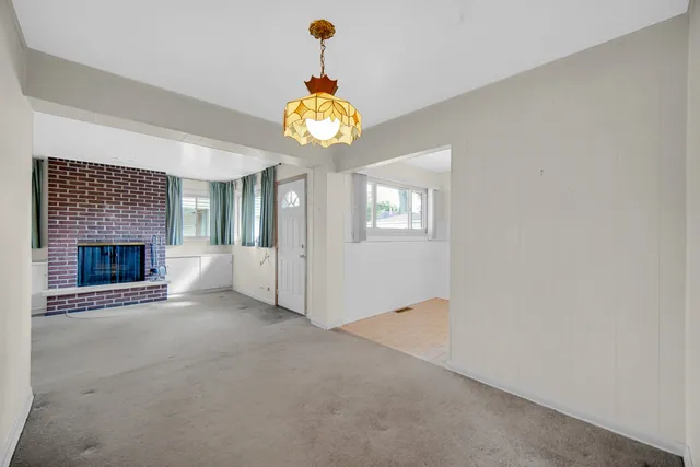 an empty room with a fireplace