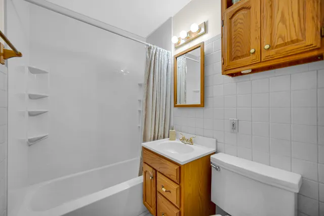 a bathroom with a sink a toilet and tub