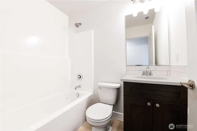 a bathroom with a sink a toilet and a bathtub