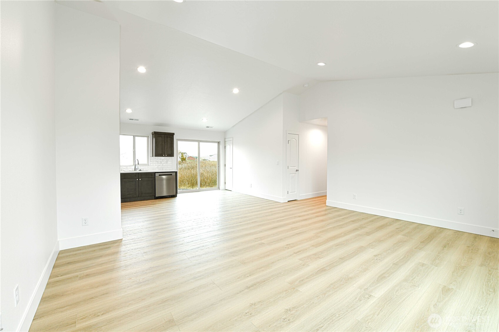 4258 Sandy Street Moses Lake, WA 98837 - Photo 4 of 19 a view of empty room with kitchen and fireplace