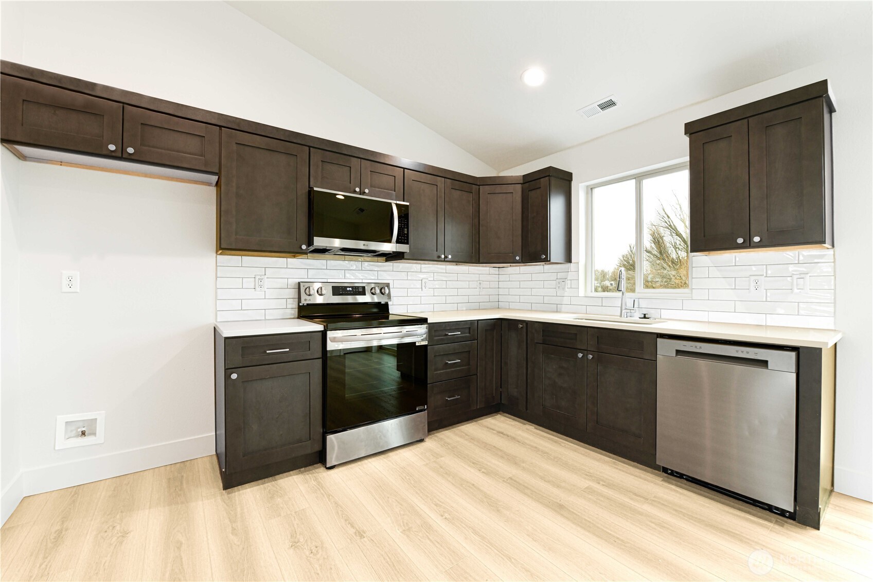 4258 Sandy Street Moses Lake, WA 98837 - Photo 5 of 19 a kitchen with a sink stove and microwave