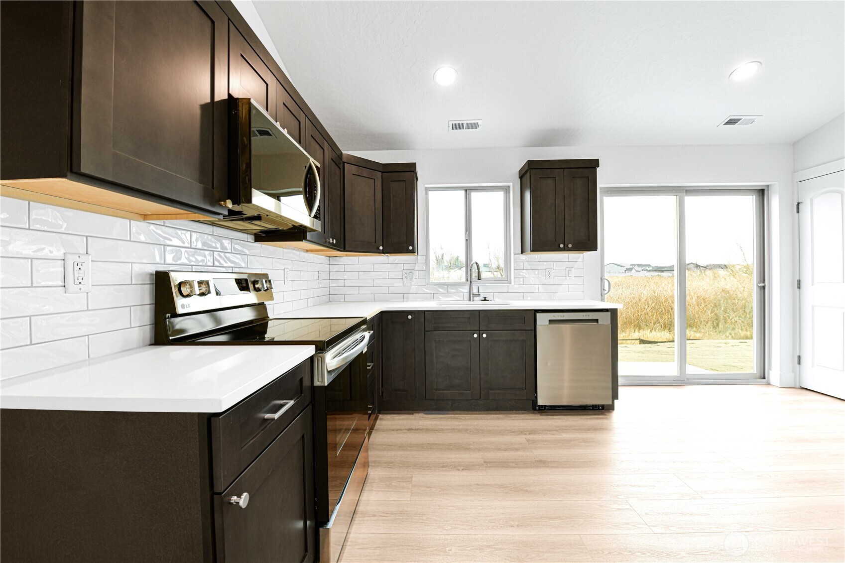 4258 Sandy Street Moses Lake, WA 98837 - Photo 6 of 19 a kitchen with stainless steel appliances granite countertop a sink stove and refrigerator