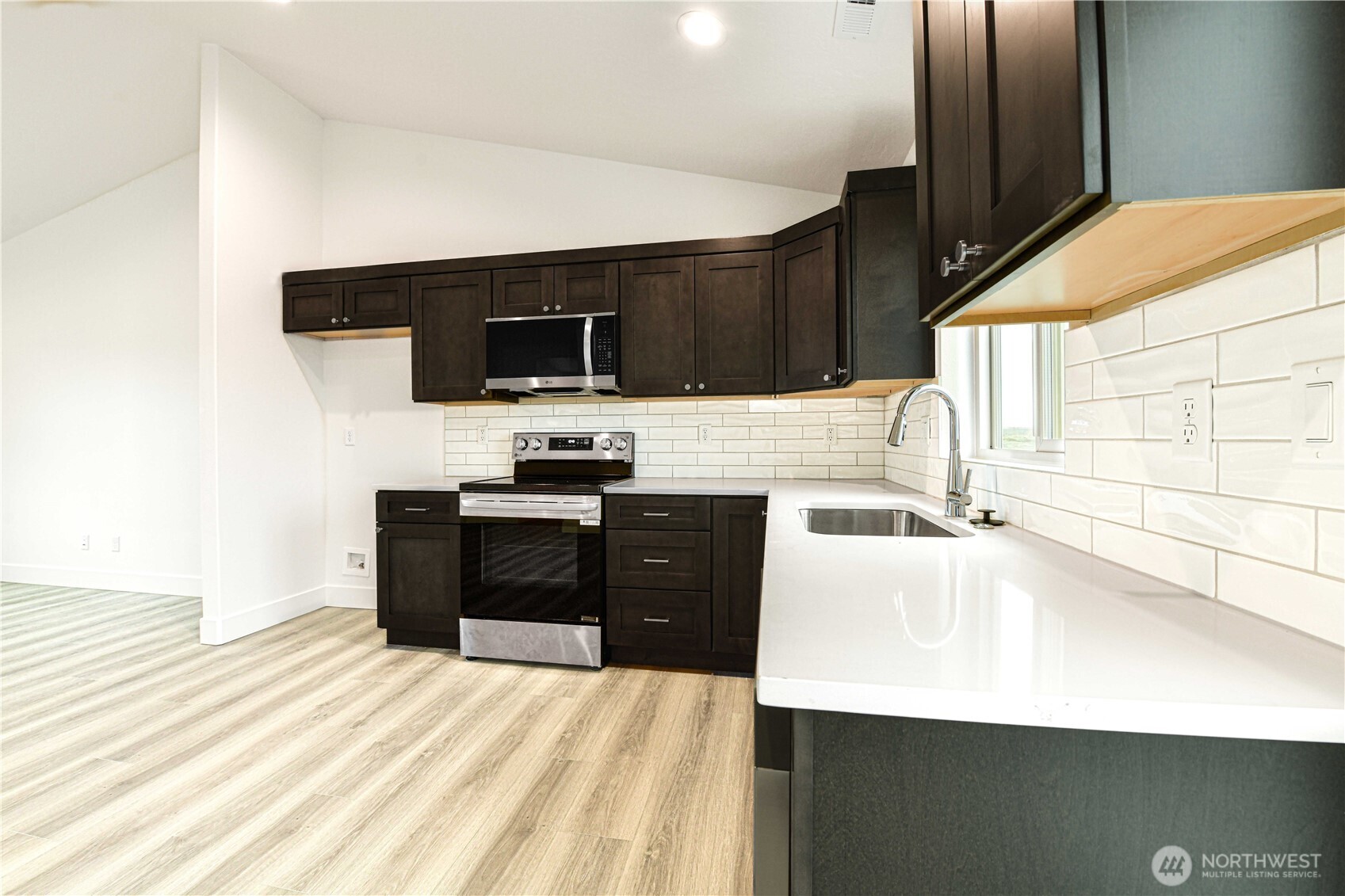 4258 Sandy Street Moses Lake, WA 98837 - Photo 7 of 19 a kitchen with a sink a stove and a refrigerator