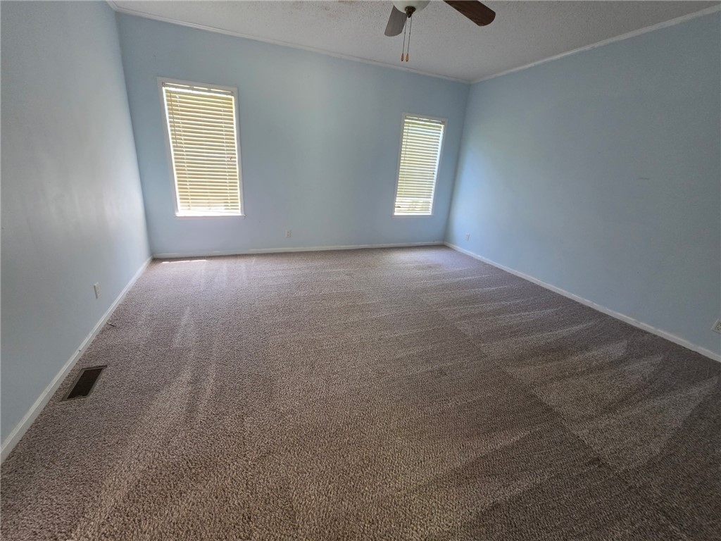 1400 Massey Road Pendleton, SC 29670 - Photo 13 of 25 This spacious bedroom offers ample natural light and a comfortable atmosphere for relaxation.
