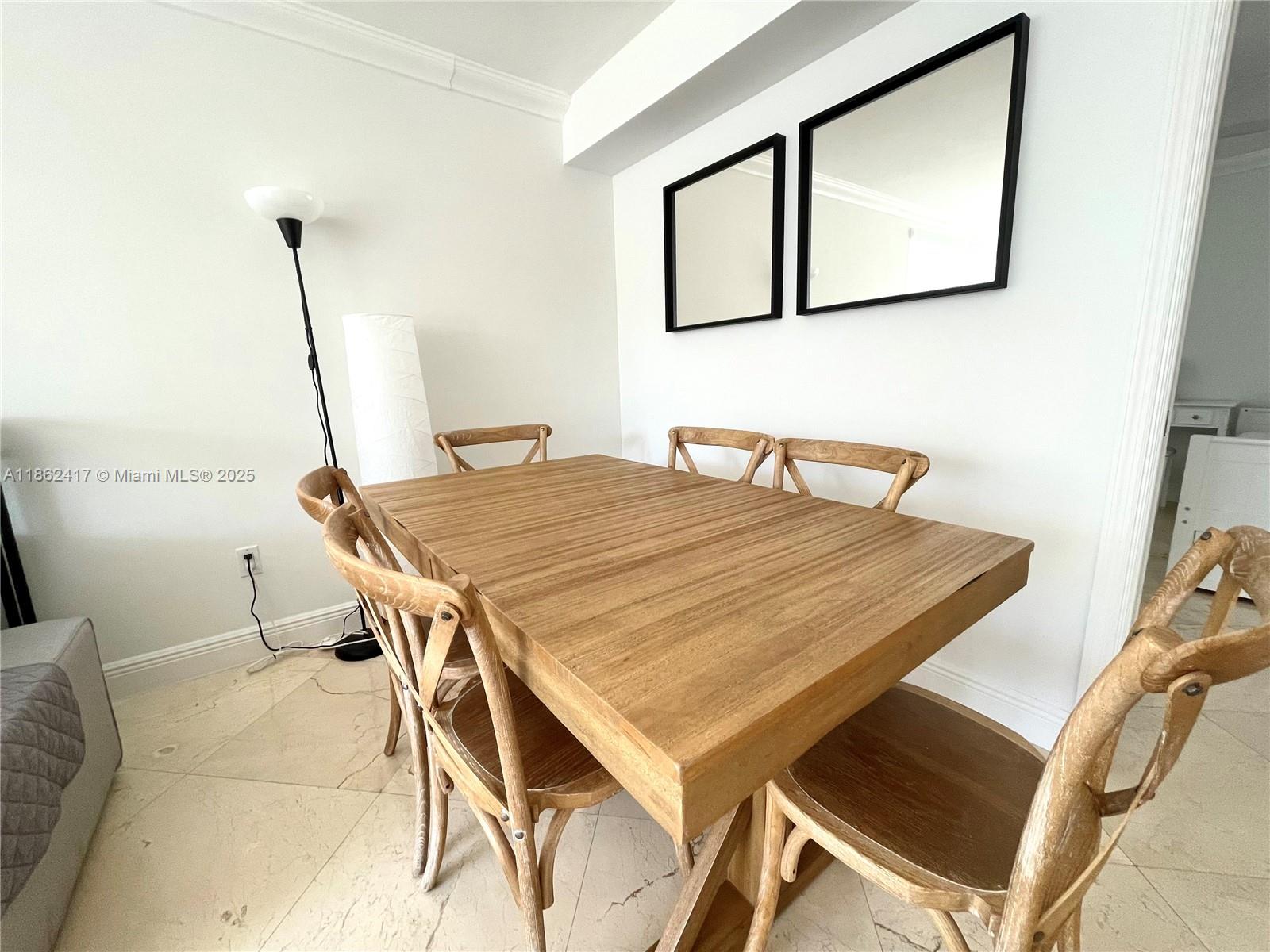 a dining room with a table and chairs