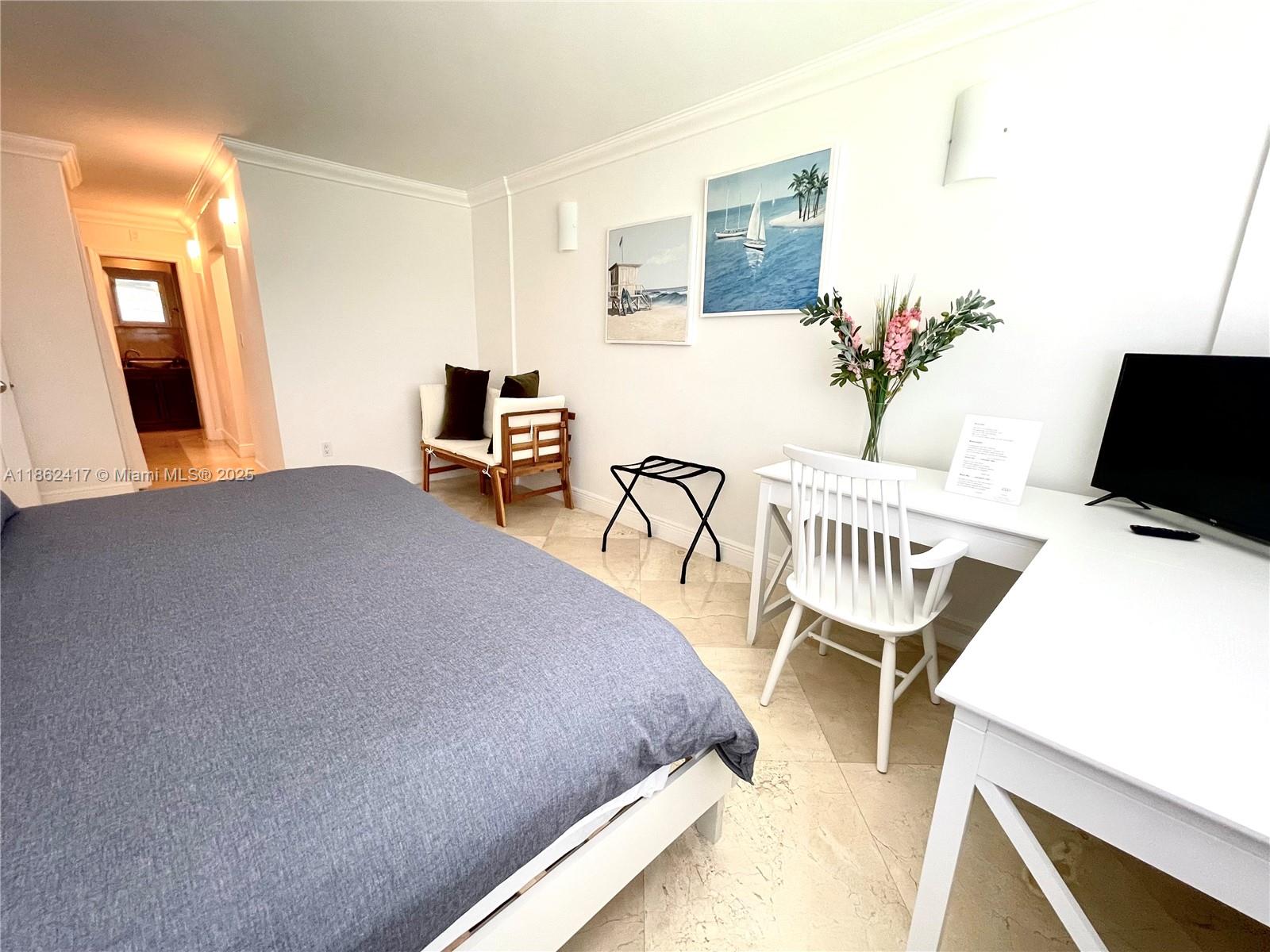 177 Ocean Ln Drive, Unit 209 Key Biscayne, FL 33149 - Photo 11 of 19 a bedroom with furniture and a wooden floor