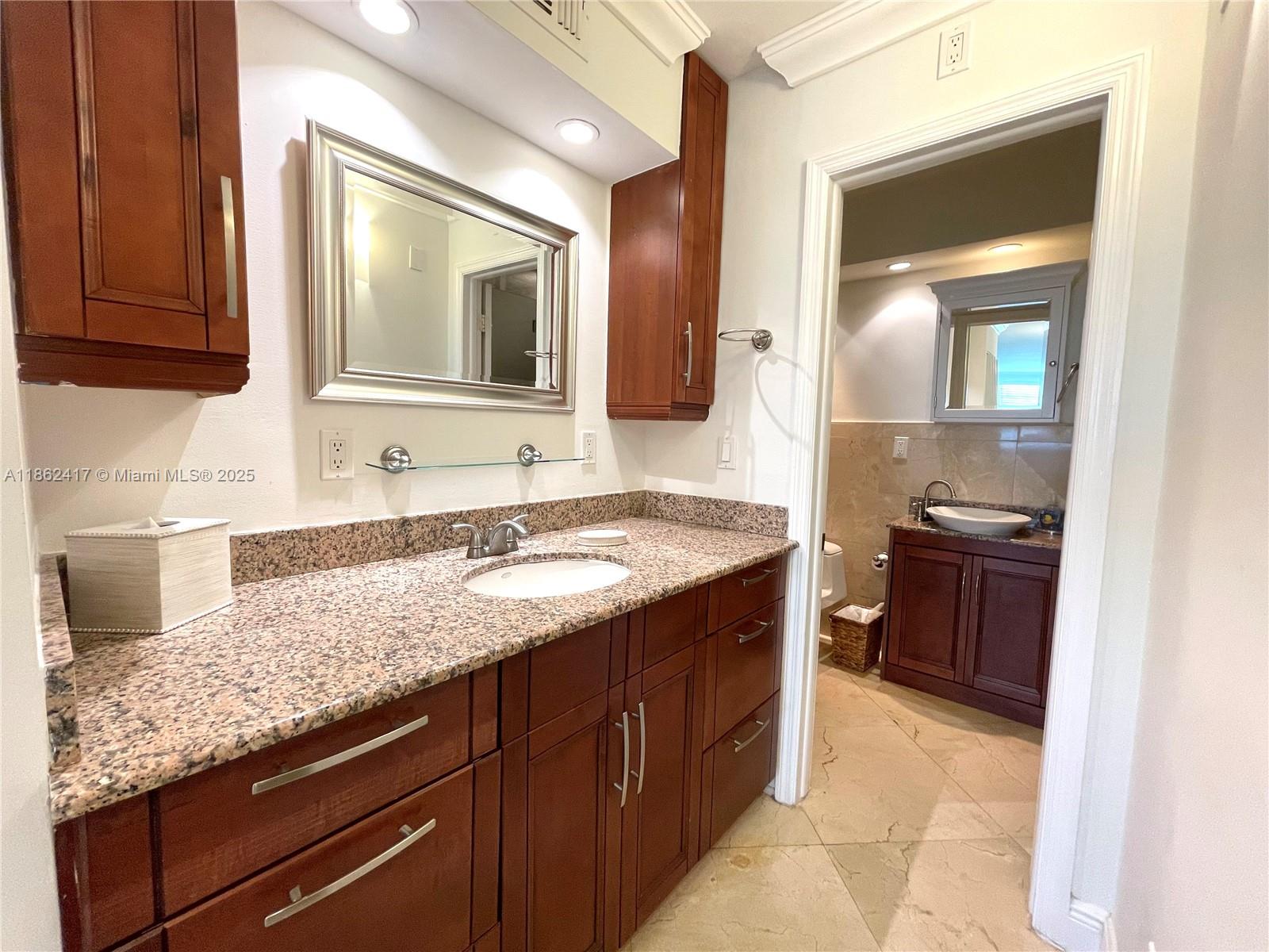 177 Ocean Ln Drive, Unit 209 Key Biscayne, FL 33149 - Photo 15 of 19 a bathroom with a granite countertop sink and a mirror