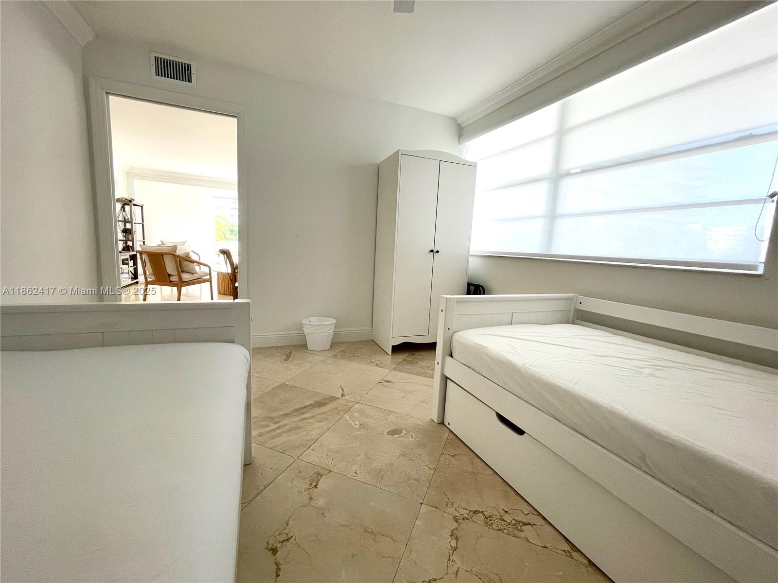 177 Ocean Ln Drive, Unit 209 Key Biscayne, FL 33149 - Photo 5 of 19 a spacious bedroom with a bed and a large window