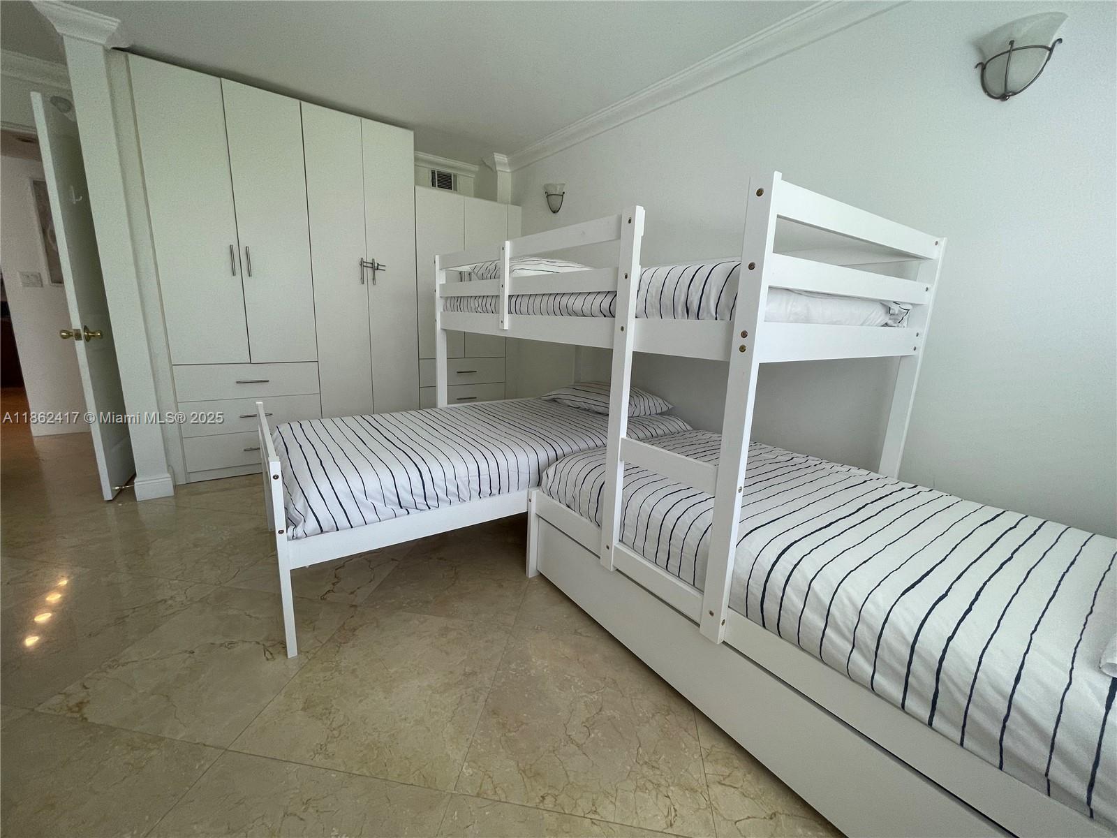 177 Ocean Ln Drive, Unit 209 Key Biscayne, FL 33149 - Photo 6 of 19 a bedroom with a bed and a window