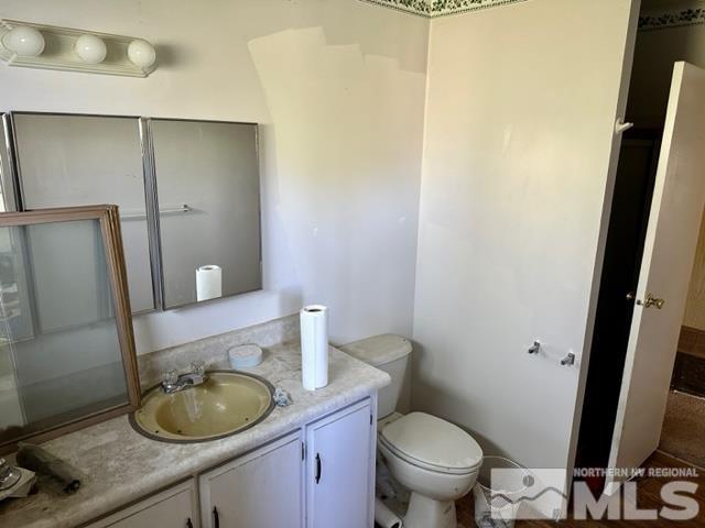 300 Scorpio Circle Reno, NV 89521 - Photo 15 of 16 a bathroom with a granite countertop toilet and a sink