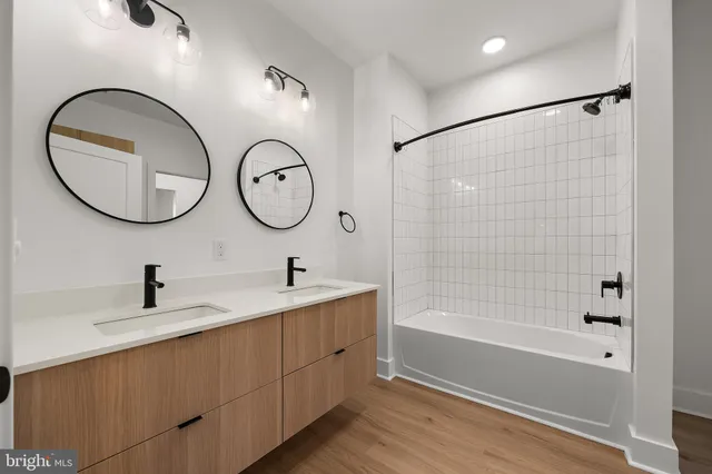 a bathroom with a tub sink and mirror