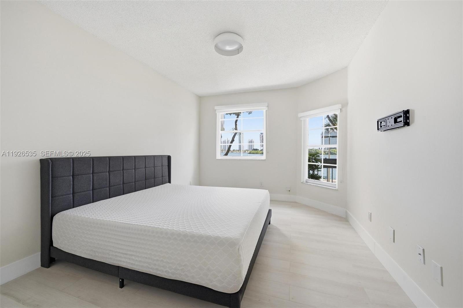 3255 Northeast 184th Street, Unit 12210 Aventura, FL 33160 - Photo 11 of 17 a bedroom with a large bed and a window