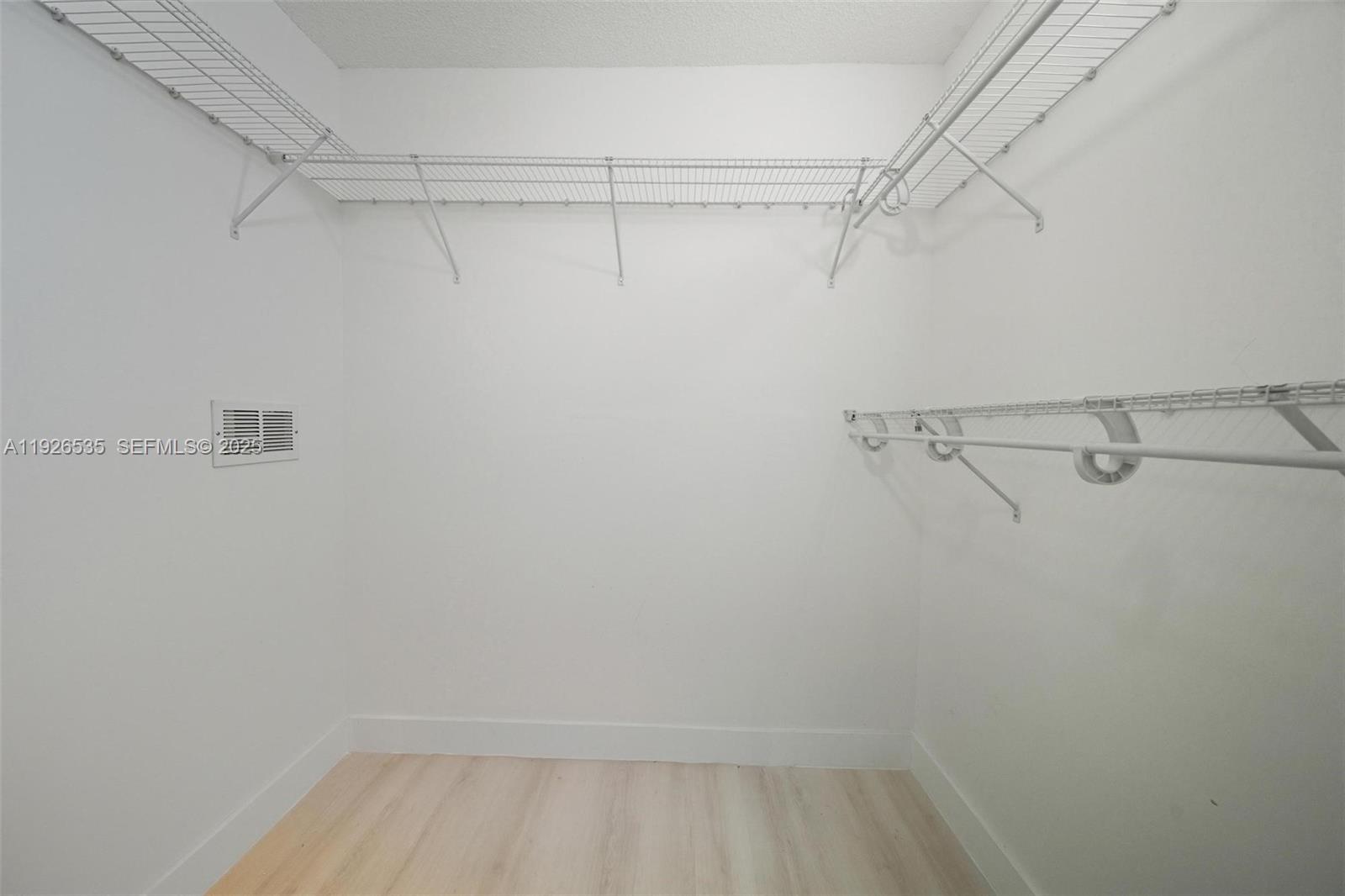 3255 Northeast 184th Street, Unit 12210 Aventura, FL 33160 - Photo 12 of 17 a view of a room with racks on the wall