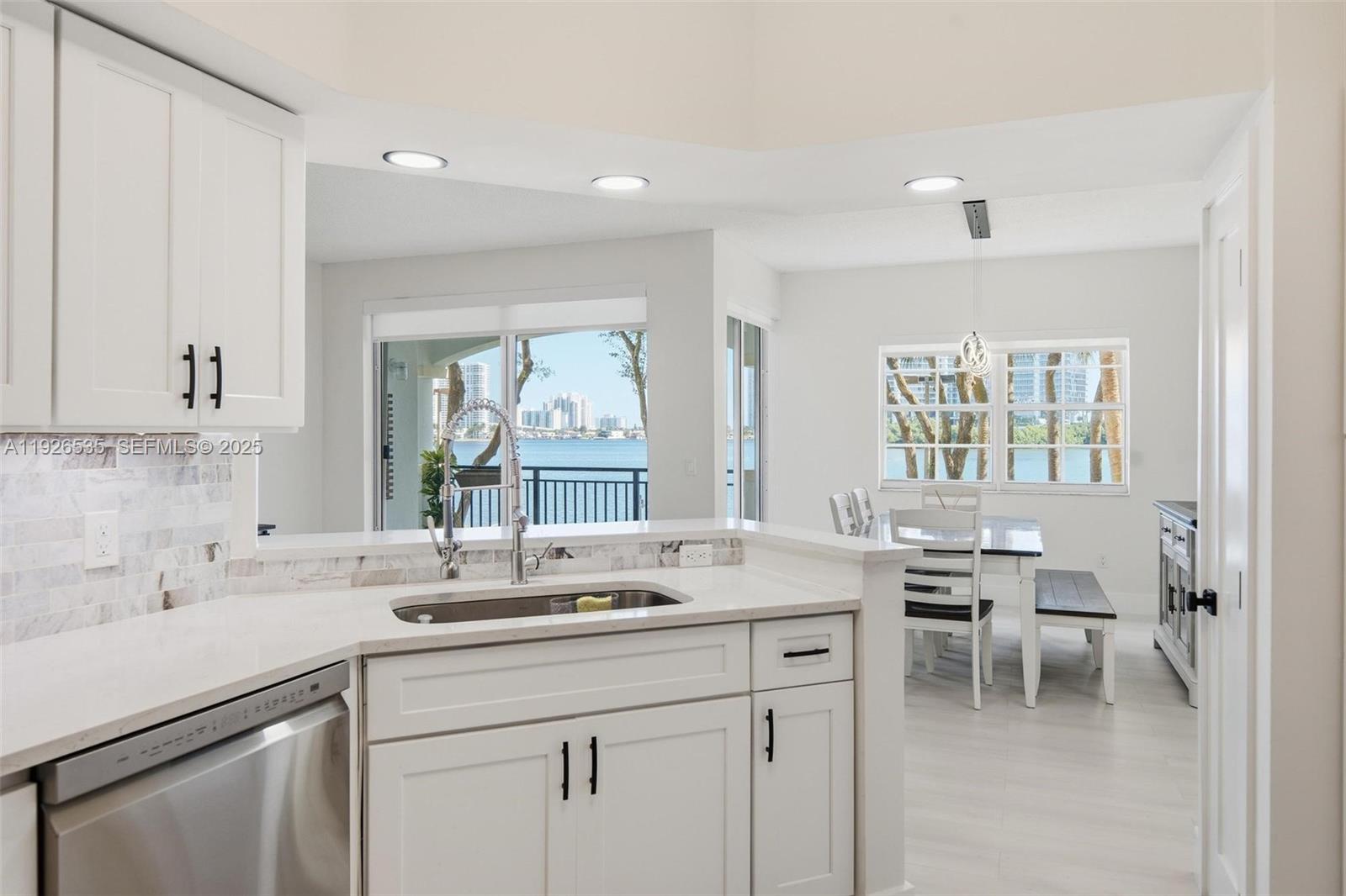 3255 Northeast 184th Street, Unit 12210 Aventura, FL 33160 - Photo 5 of 17 a kitchen with a sink stove and cabinets