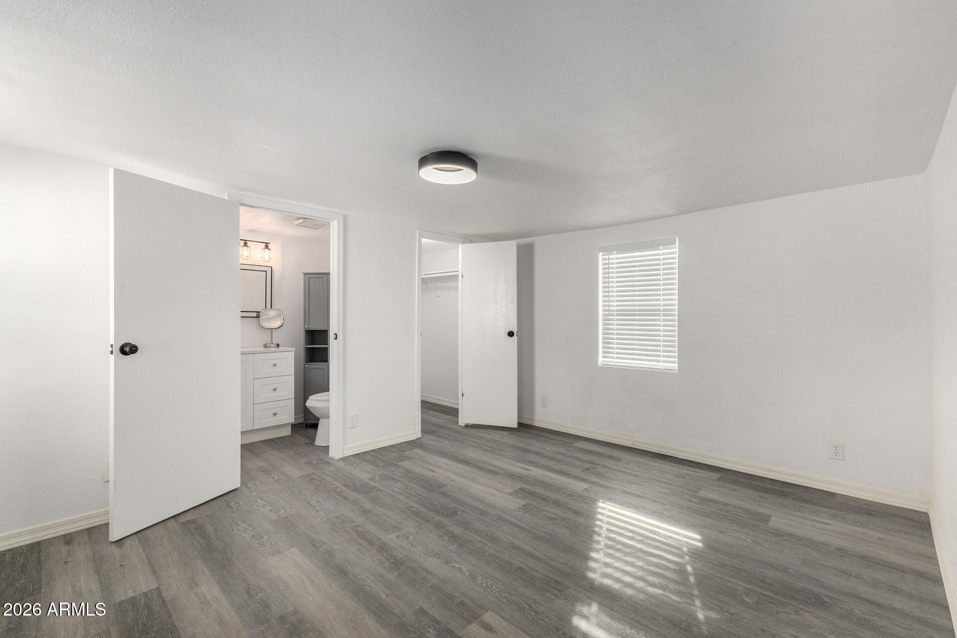 555 West Warner Road, Unit 125 Chandler, AZ 85225 - Photo 16 of 29 an empty room with wooden floor and windows
