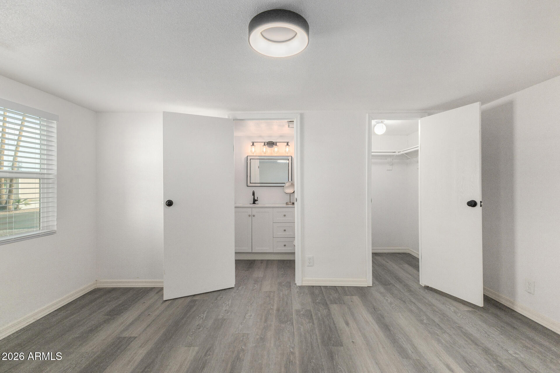 555 West Warner Road, Unit 125 Chandler, AZ 85225 - Photo 18 of 29 an empty room with wooden floor and windows