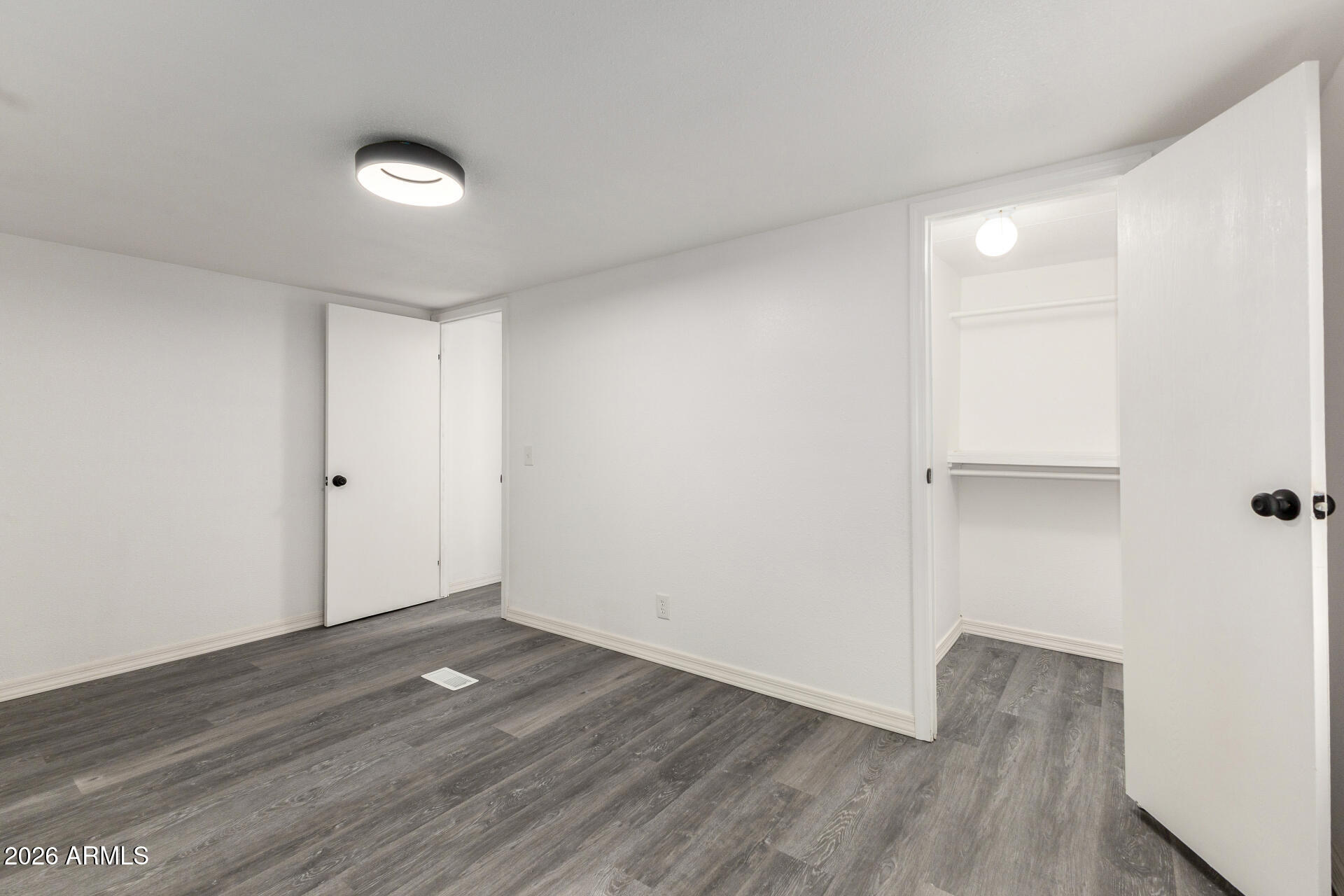 555 West Warner Road, Unit 125 Chandler, AZ 85225 - Photo 23 of 29 a view of an empty room with wooden floor