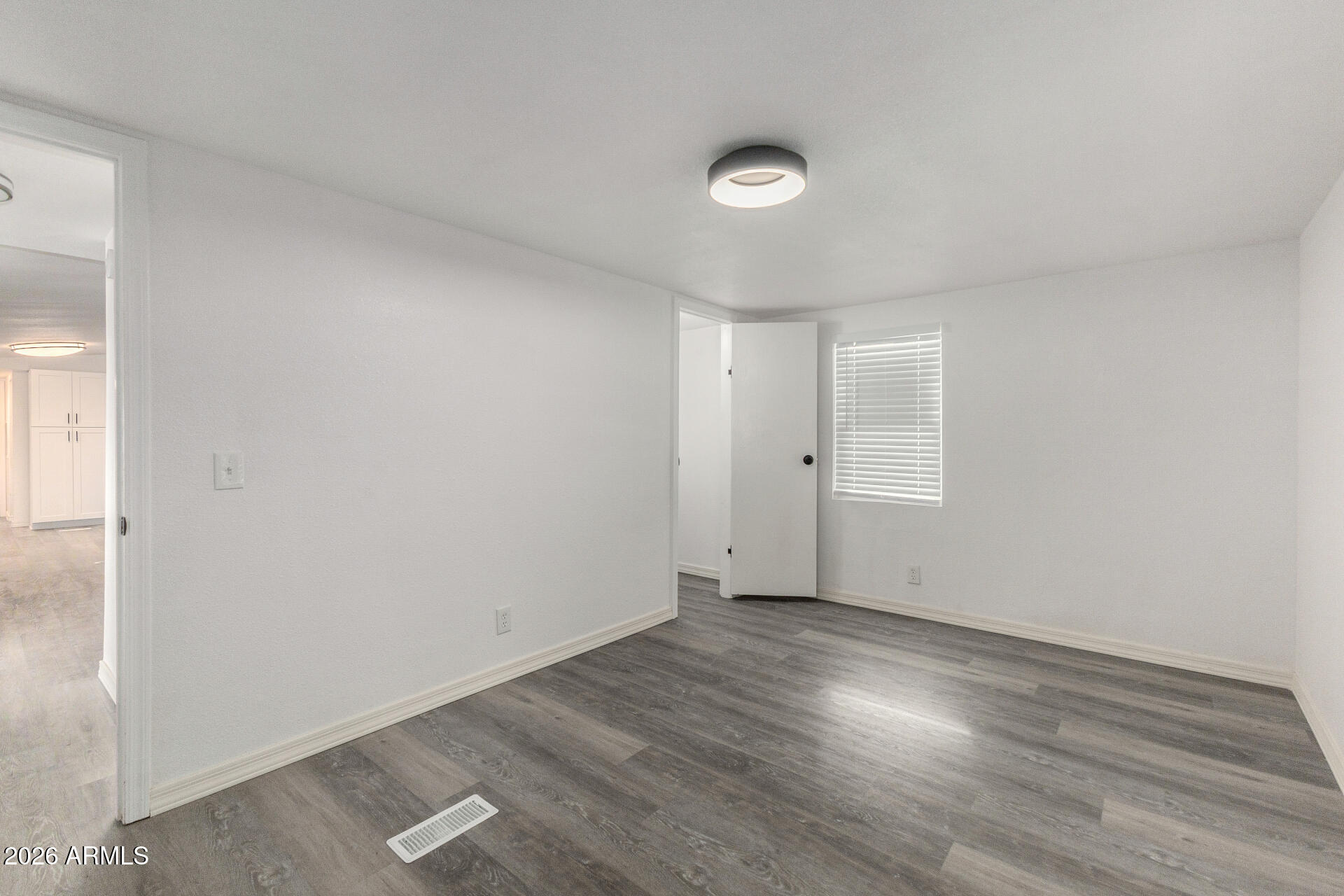 555 West Warner Road, Unit 125 Chandler, AZ 85225 - Photo 24 of 29 an empty room with wooden floor and windows