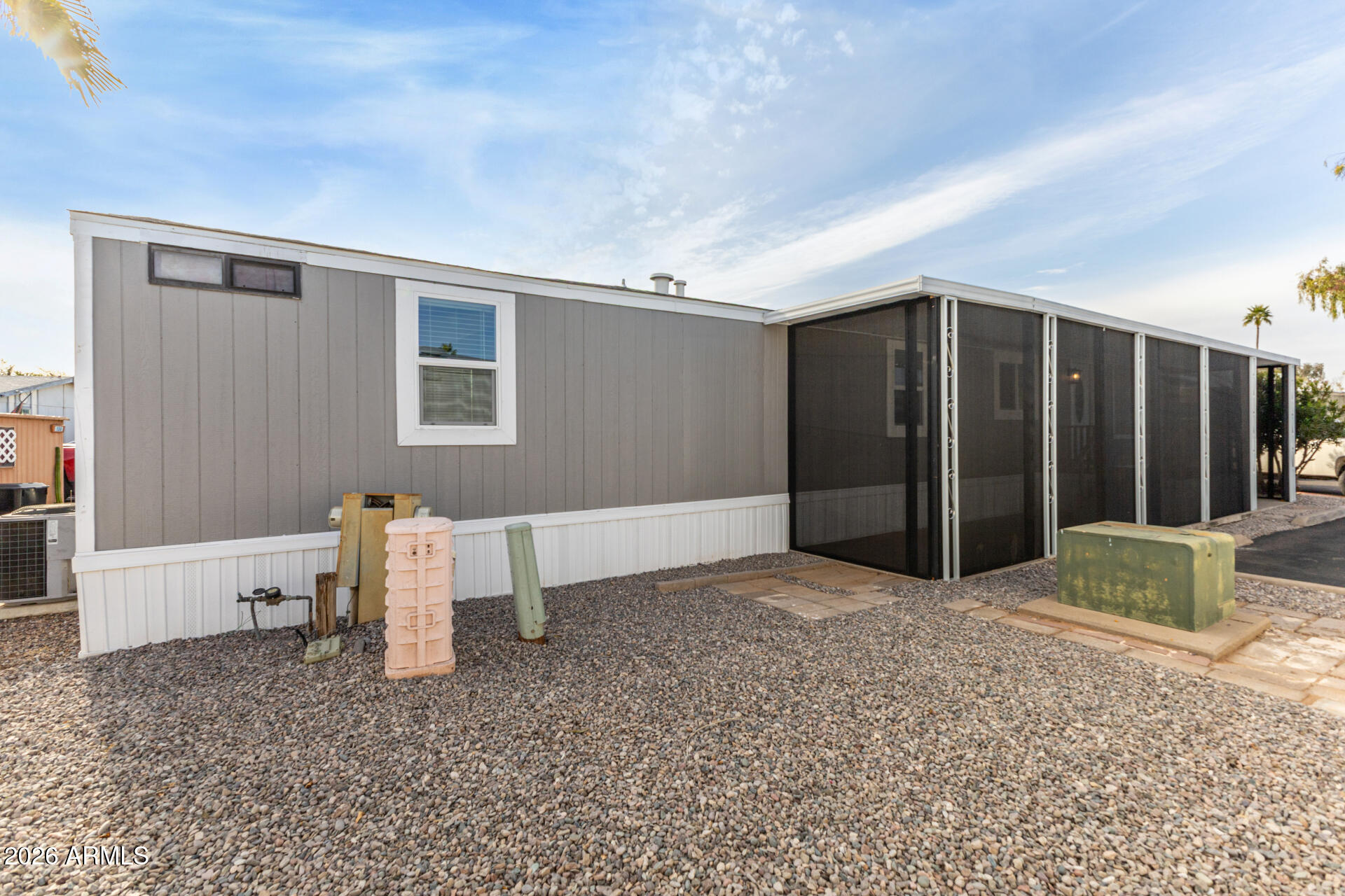 555 West Warner Road, Unit 125 Chandler, AZ 85225 - Photo 4 of 29 a view of an empty room with wooden floor and a cabinet