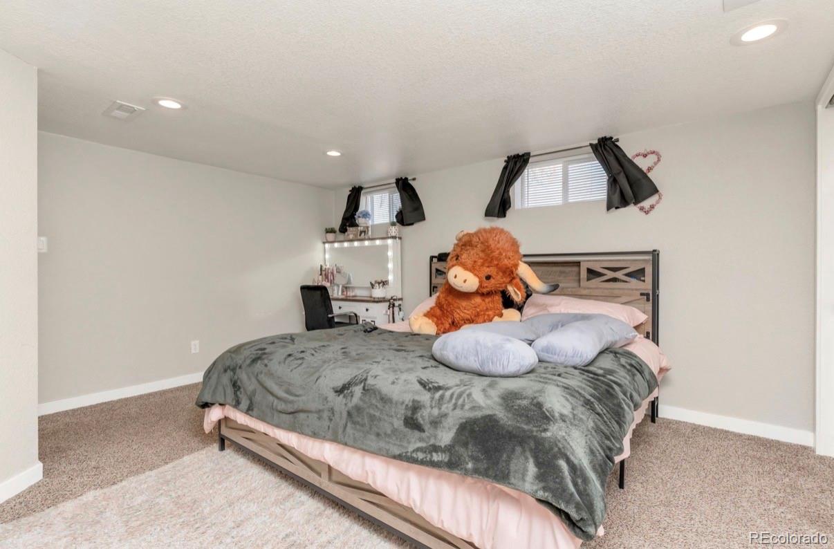 9271 Travis Street Thornton, CO 80229 - Photo 12 of 25 a bedroom with a bed and window
