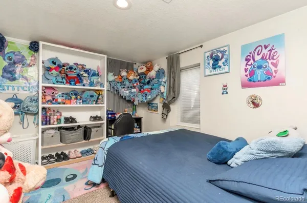 a bedroom with toys and a book shelf