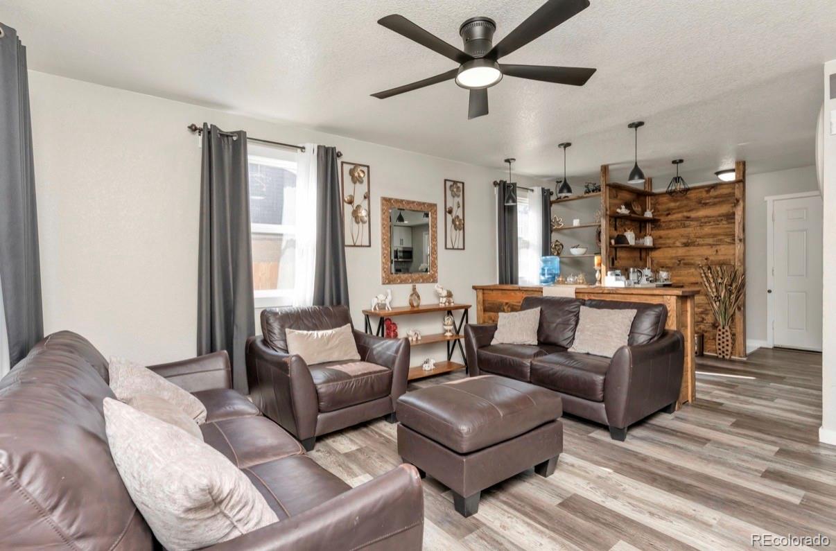 9271 Travis Street Thornton, CO 80229 - Photo 7 of 25 a living room with furniture and a large window