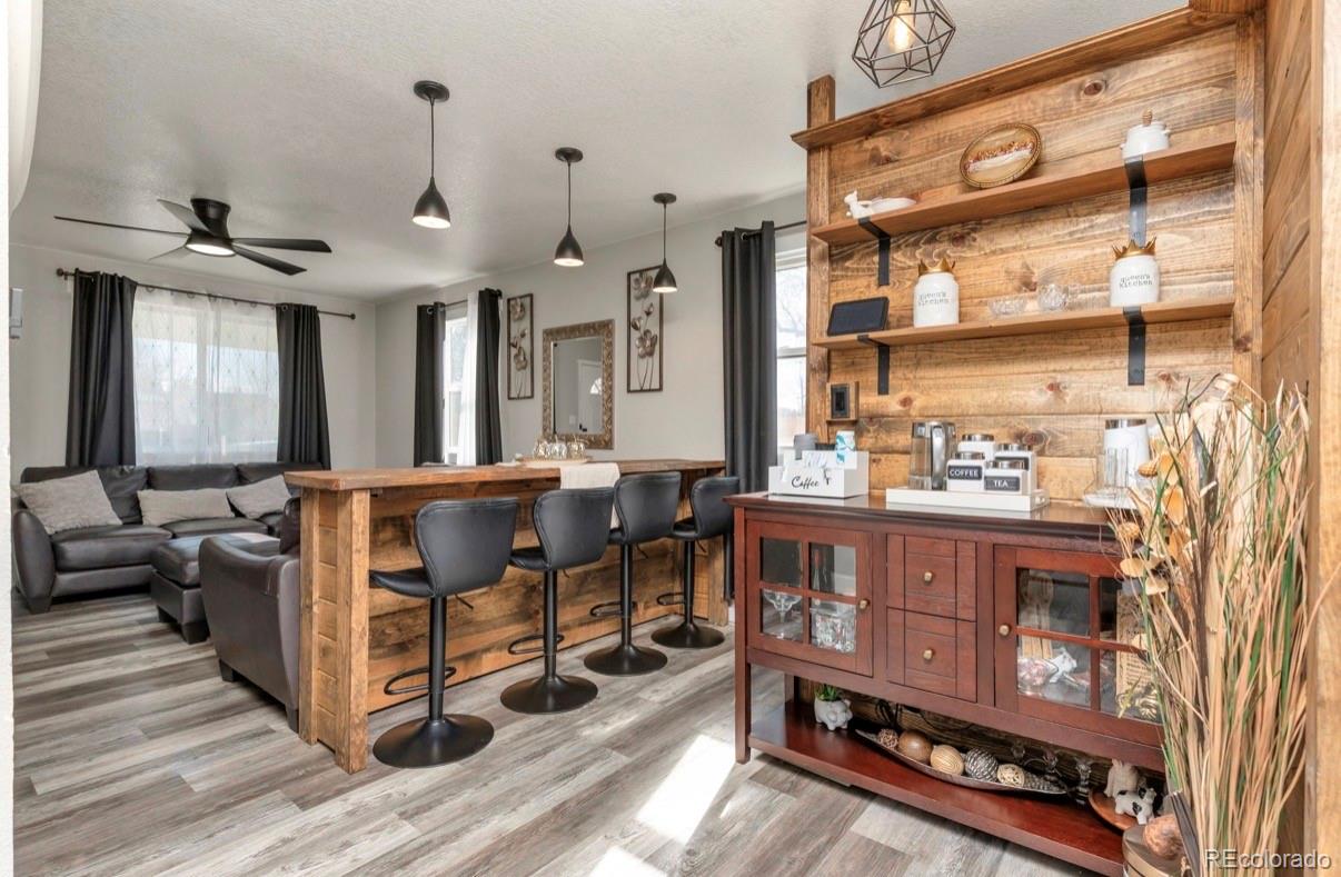 9271 Travis Street Thornton, CO 80229 - Photo 9 of 25 a view of living room with furniture and wooden floor