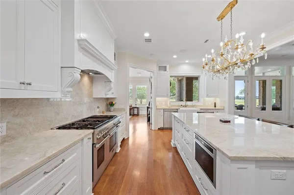 a hallway view with wooden floor and staircase