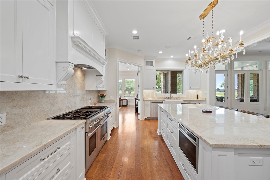 5108 Inverness Drive Bryan, TX 77802 - Photo 11 of 34 a large white kitchen with stainless steel appliances
