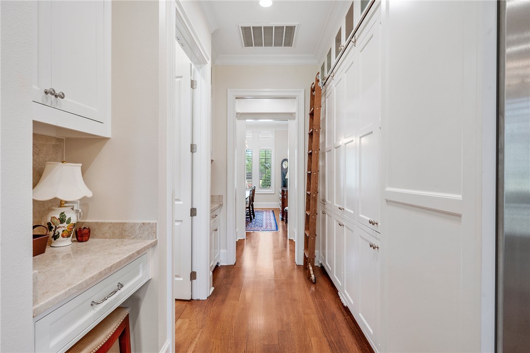 5108 Inverness Drive Bryan, TX 77802 - Photo 12 of 34 a hallway view with wooden floor and staircase