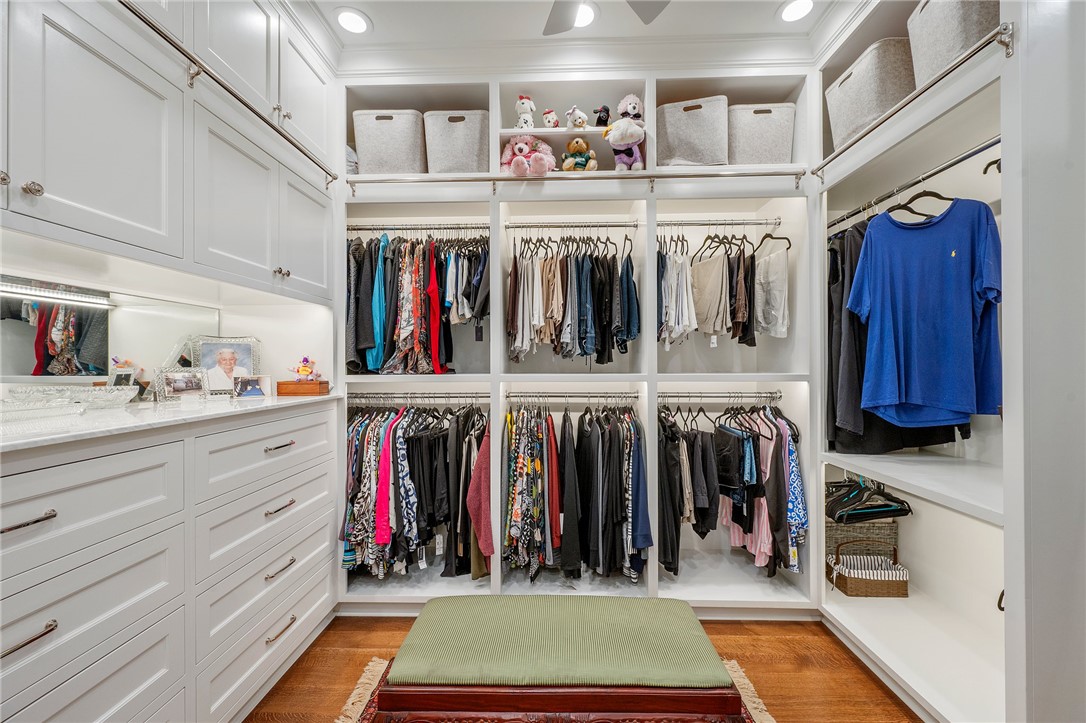 5108 Inverness Drive Bryan, TX 77802 - Photo 18 of 34 a view of walk in closet with clothes and shoes