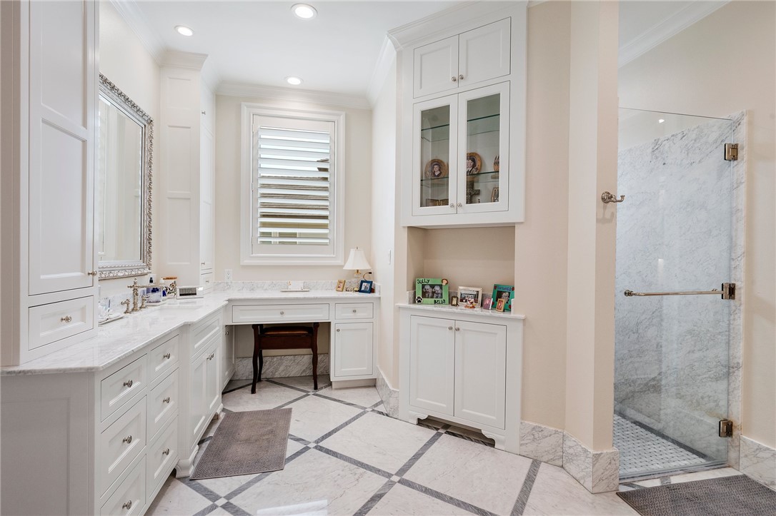 5108 Inverness Drive Bryan, TX 77802 - Photo 19 of 34 a room with a sink a mirror and a shower
