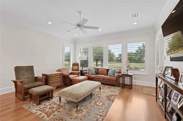 a living room with furniture and wooden floor